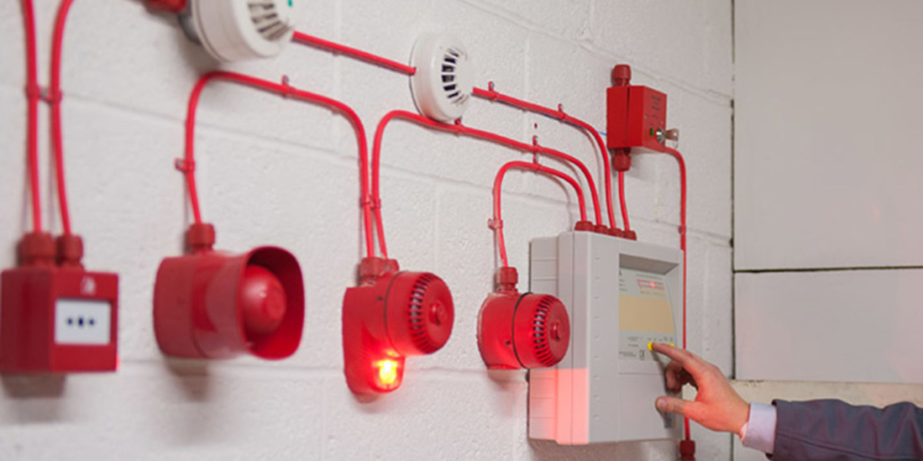 Fire Alarm System Commissioning Process on a wall.